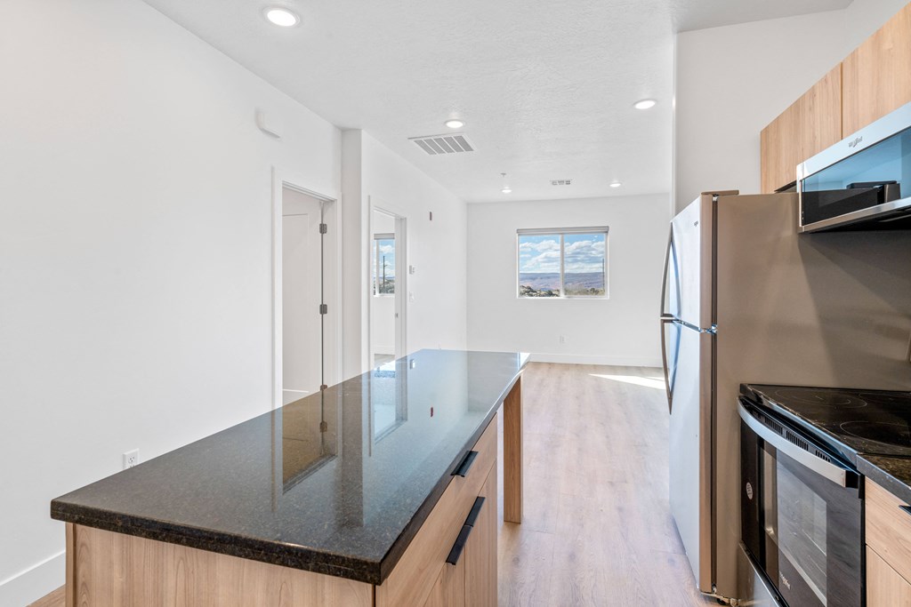 a kitchen with an island and stainless steel appliances