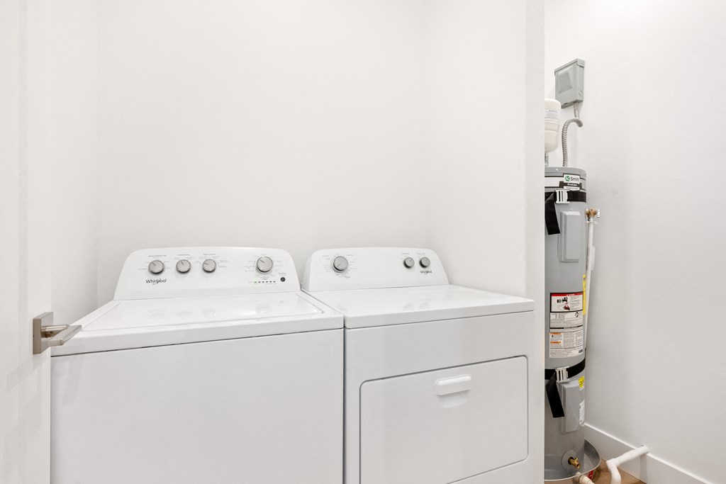 a washer and dryer in a room with a white wall