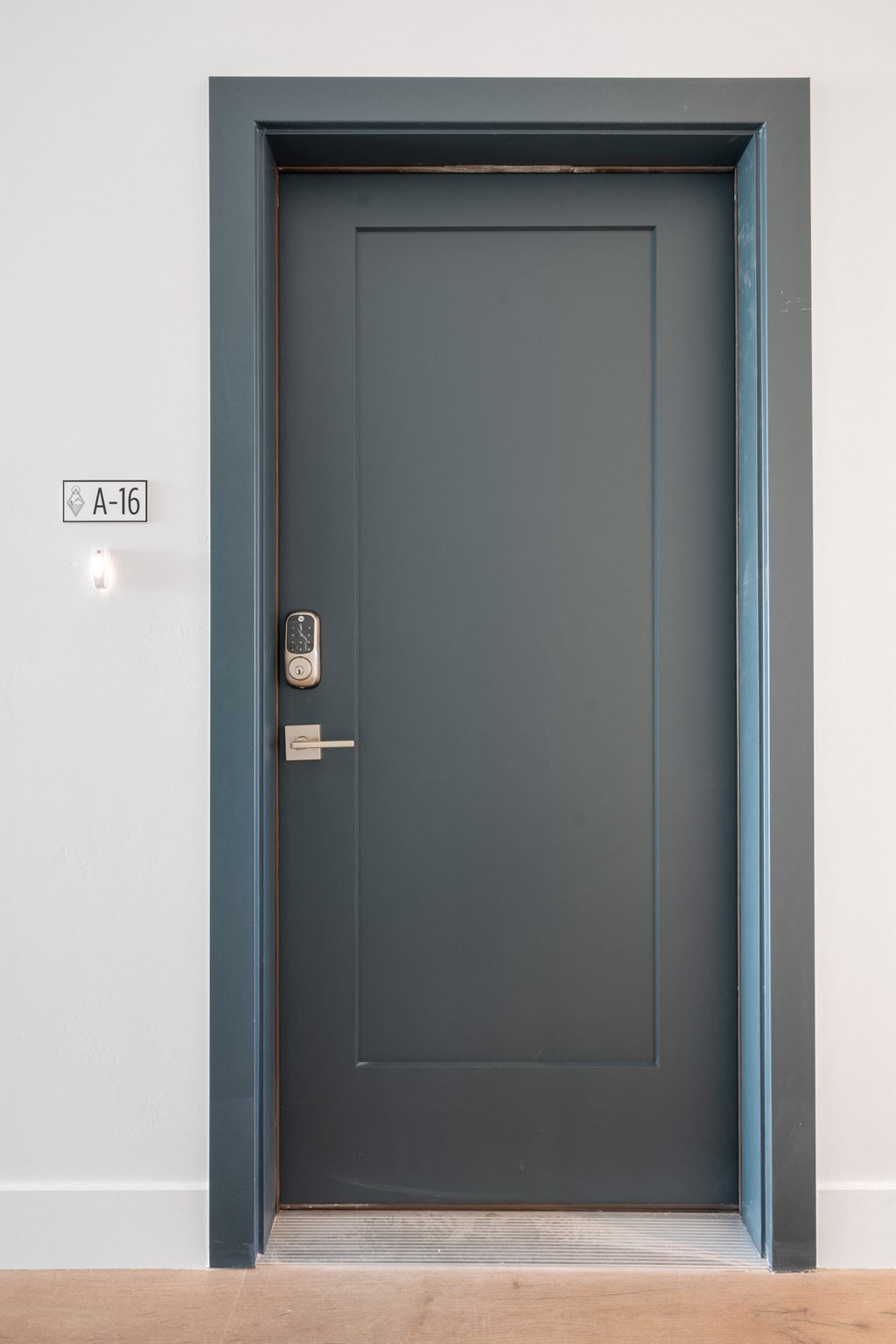 a black door with a white wall and a blue doorframe