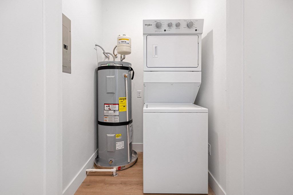 a white washer and dryer in a room with white walls