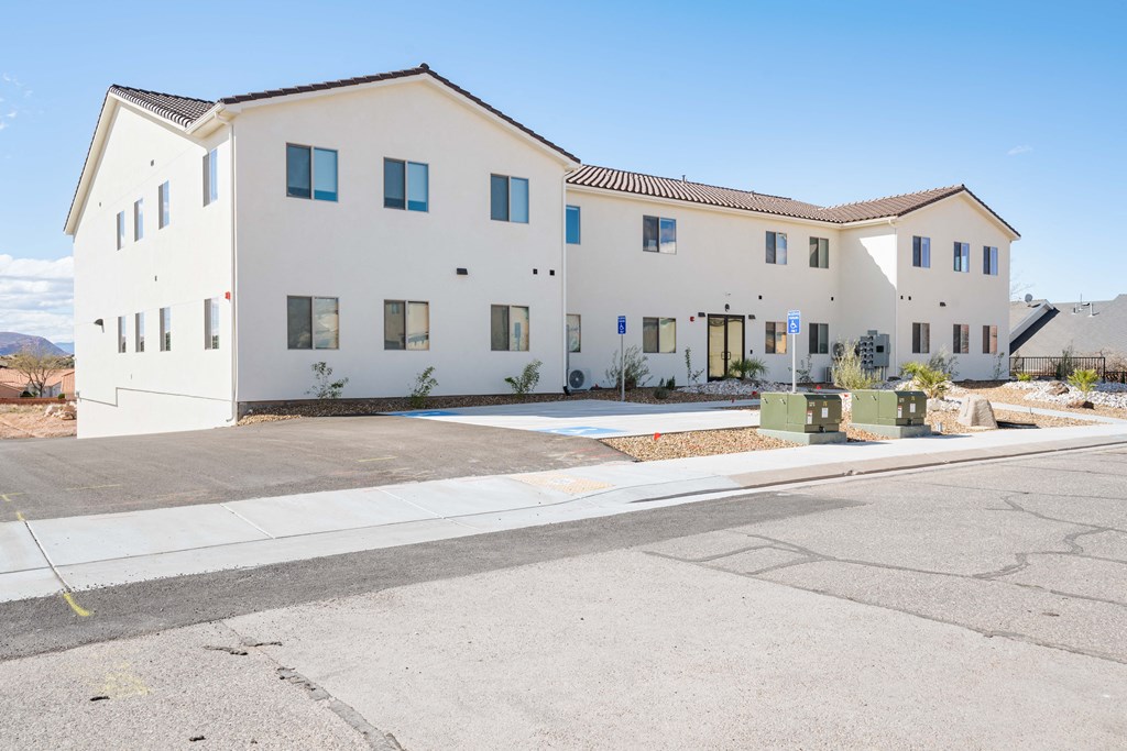 a white building with a street in front of it