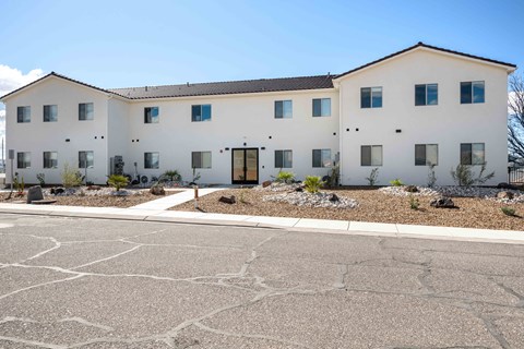 a large white building with a street in front of it