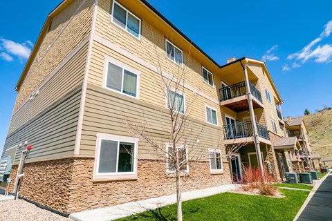 A multi-story residential building with a balcony on the upper floor.