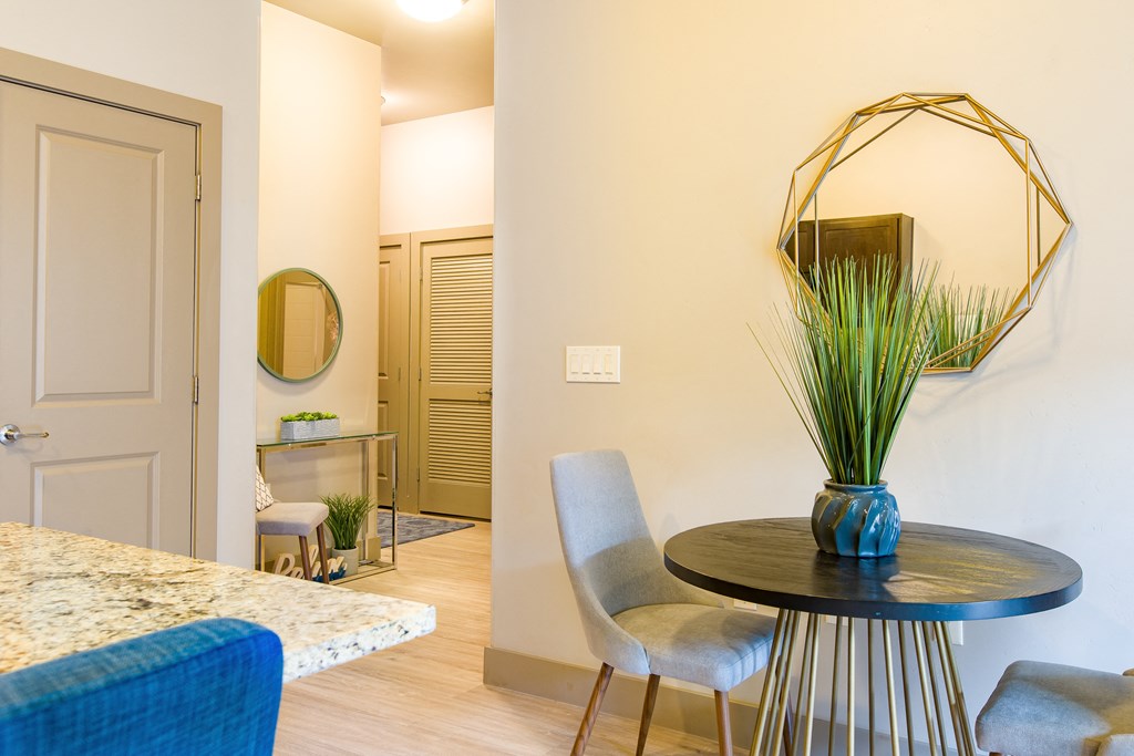 a dining room with a table and chairs and a mirror a dining room with a table and chairs and a mirror at Sugar House Apartments By Urbana, Salt Lake City, UT, 84105