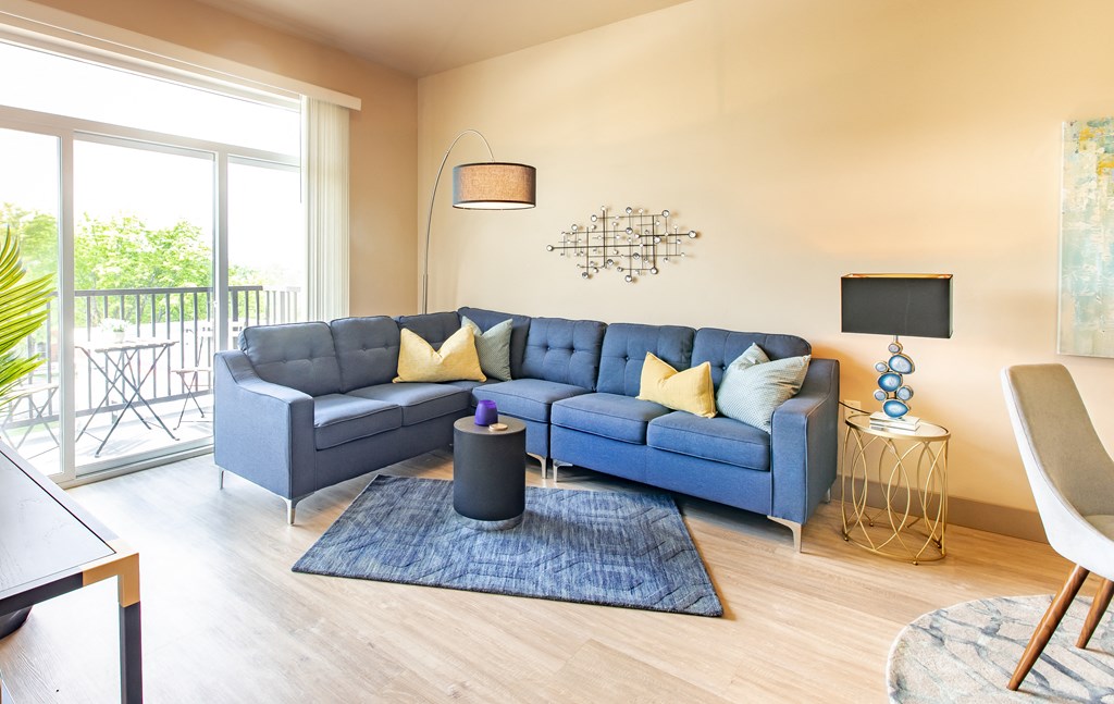 a living room with a blue couch and a rug at Sugar House Apartments By Urbana, Salt Lake City, UT, 84105