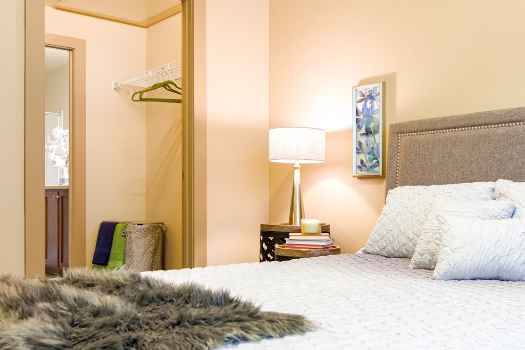 a bedroom with a large bed and a mirror at Sugar House Apartments By Urbana, Salt Lake City, UT, 84105