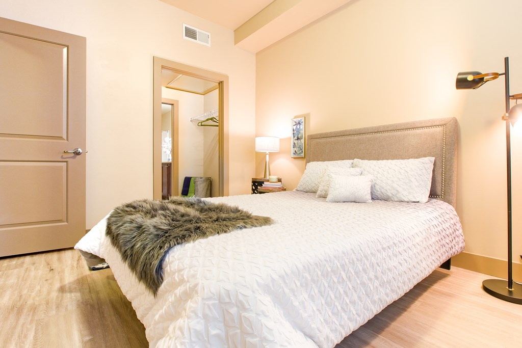 a bedroom with a large bed and a rug at Sugar House Apartments By Urbana, Salt Lake City, UT, 84105