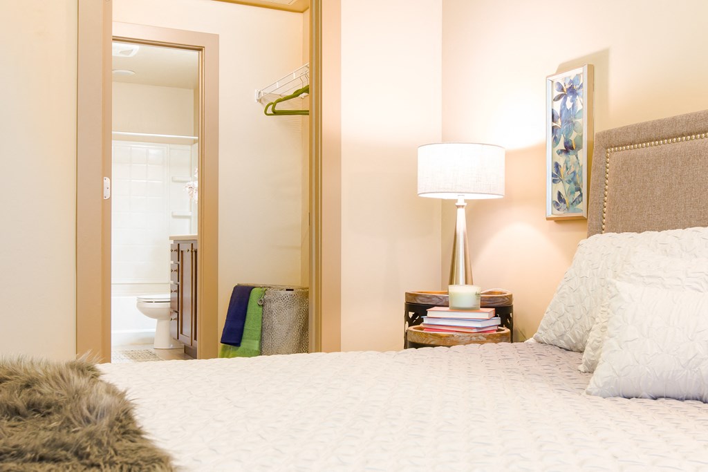 a bedroom with a bed and a mirror and a bathroom at Sugar House Apartments By Urbana, Salt Lake City, UT, 84105