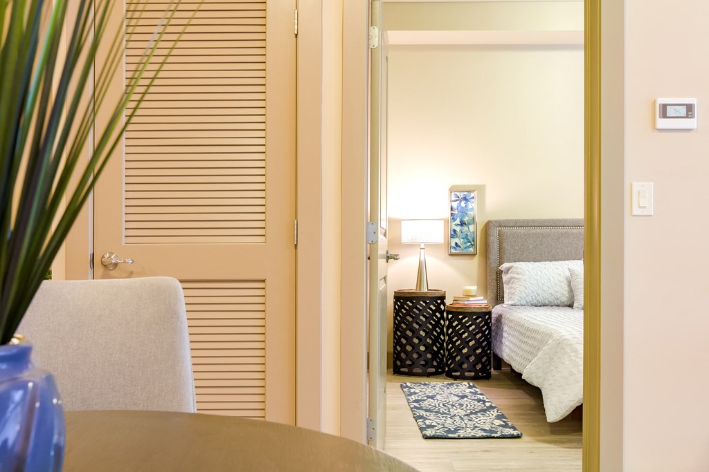 a bedroom with a bed and a table and a chair at Sugar House Apartments By Urbana, Salt Lake City, UT, 84105