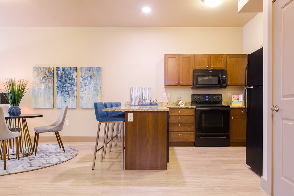 a kitchen and dining room with a table and chairs at Sugar House Apartments By Urbana, Salt Lake City, UT, 84105