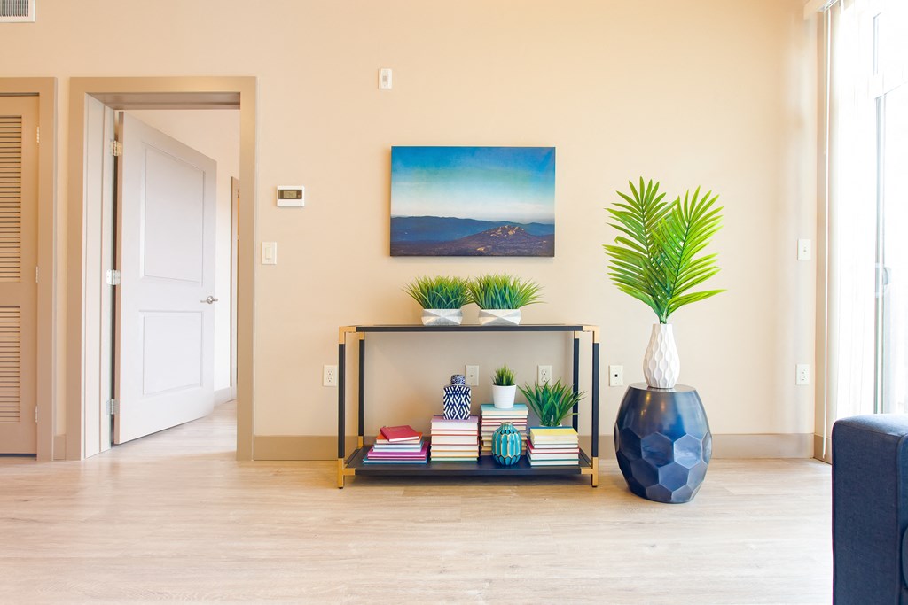 a living room with a table and a vase with plants at Sugar House Apartments By Urbana, Salt Lake City, UT, 84105