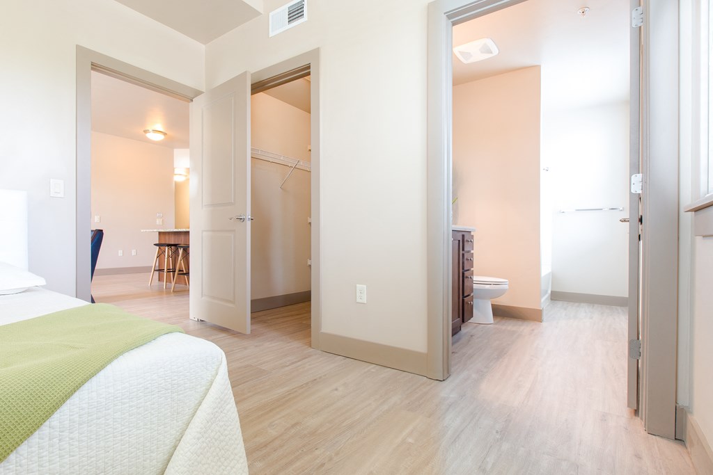 a room with a bed and a bathroom and a closet at Sugar House Apartments By Urbana, Salt Lake City, UT, 84105