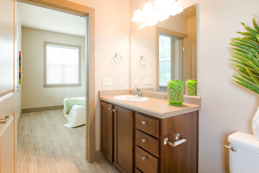 a bathroom with a large mirror and a sink at Sugar House Apartments By Urbana, Salt Lake City, UT, 84105
