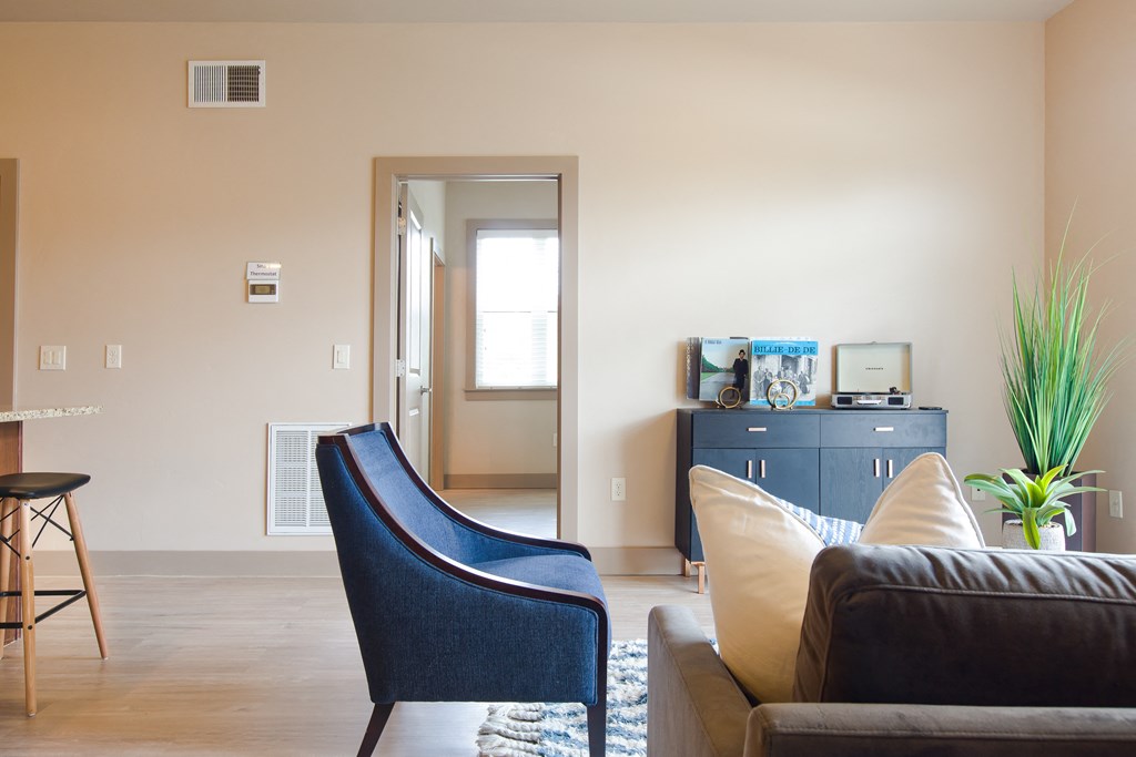 a living room with a couch chair and desk in a 555 waverly unit at Sugar House Apartments By Urbana, Salt Lake City, UT, 84105