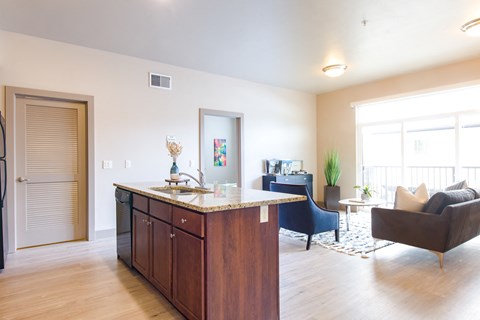 a living room with a kitchen and a couch and a table