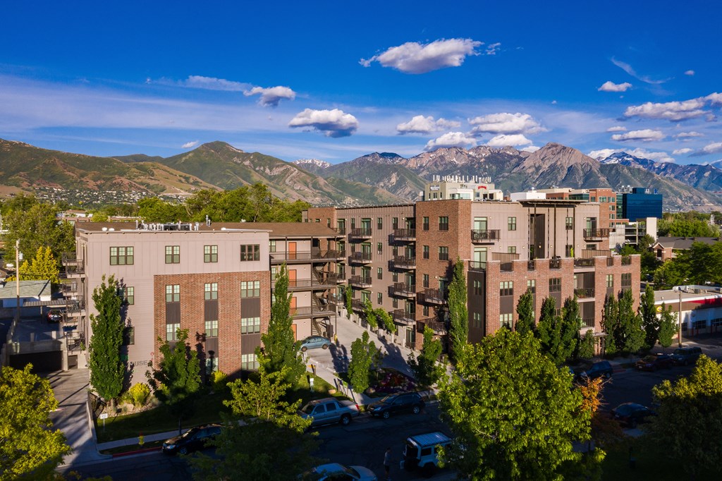 an aerial view of an apartment complex with mountains in the background at Sugar House Apartments By Urbana, Salt Lake City, UT, 84105