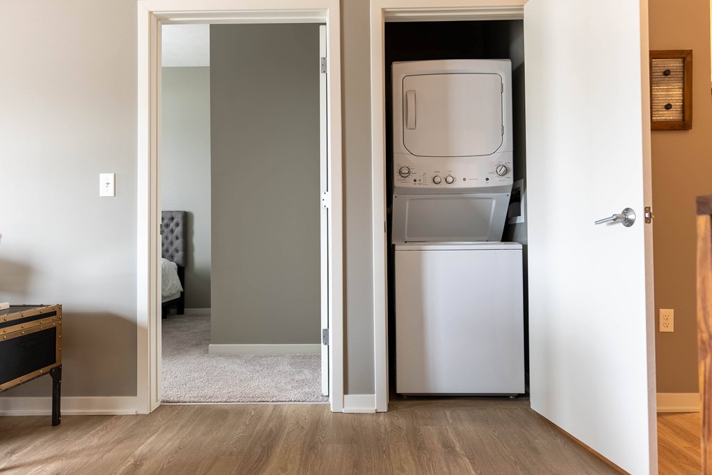 a room with a refrigerator and a washer and dryer in it