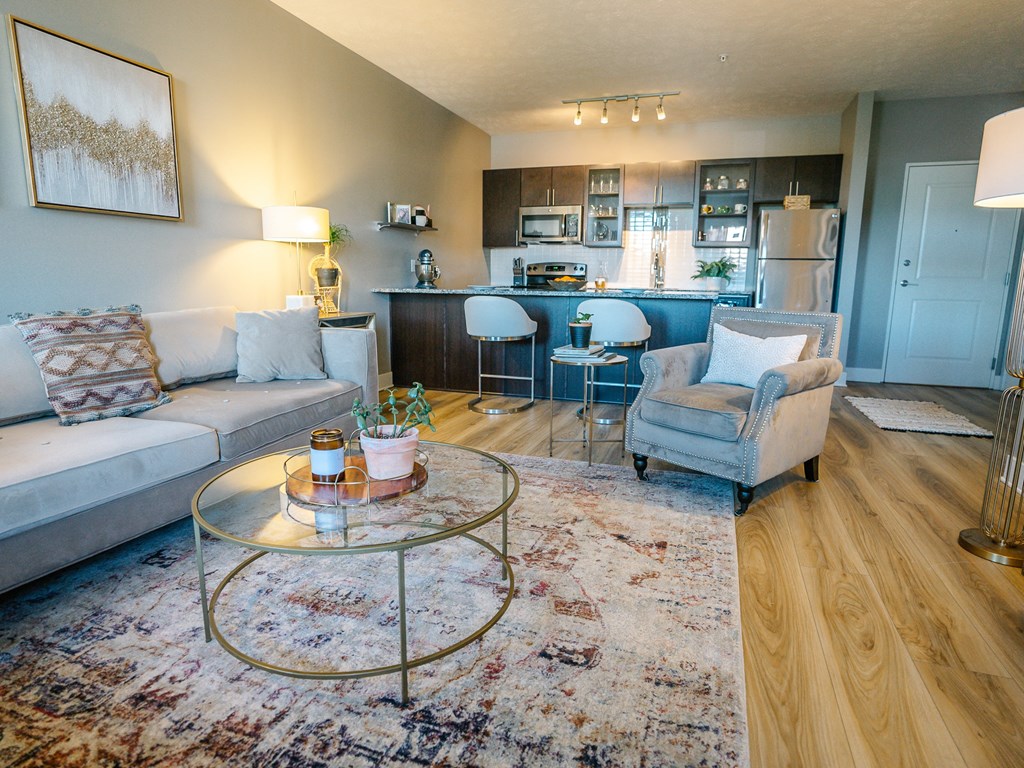 a living room and kitchen with a couch and a table