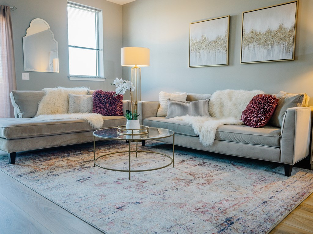 a living room with couches and a rug
