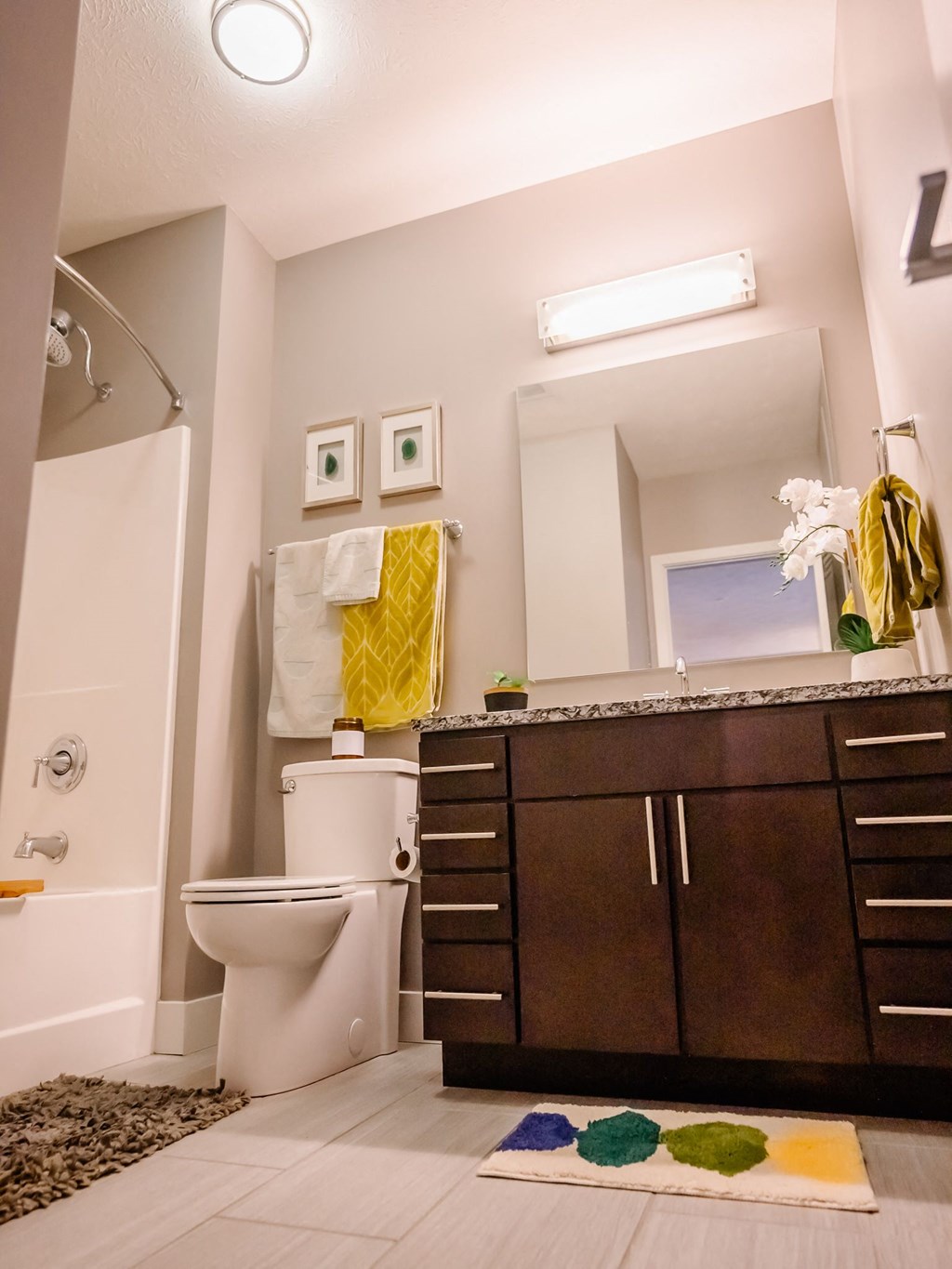 a bathroom with a toilet and a sink and a mirror