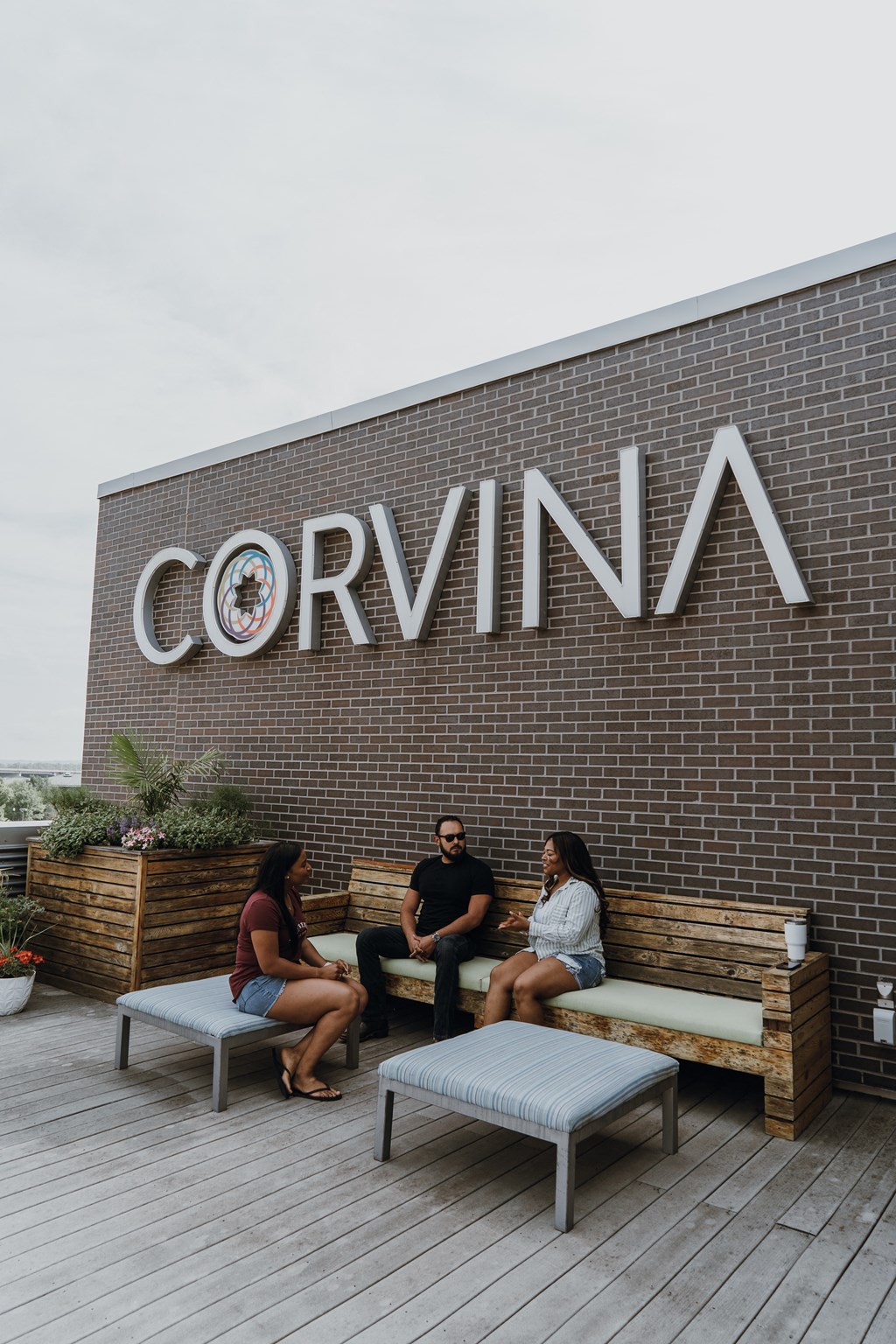 people sitting on benches outside of the building