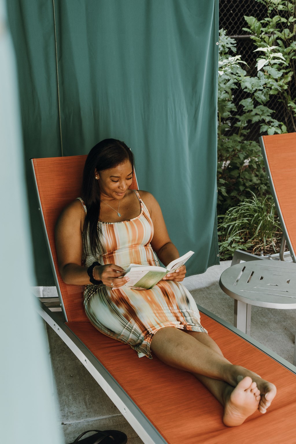 a woman sitting on a bench reading a book
