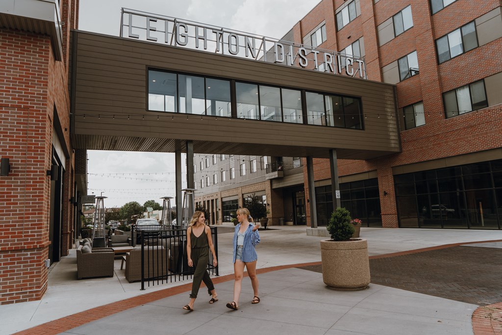 two women walking in front of the echo street building