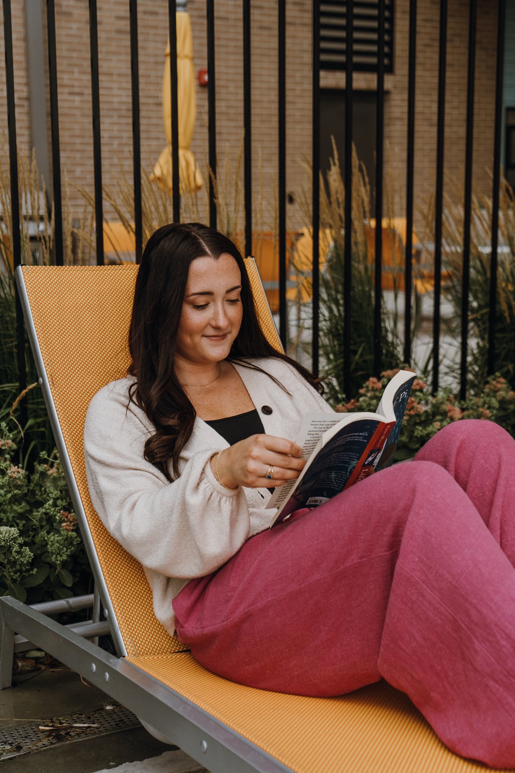 a woman sitting in a chair reading a book