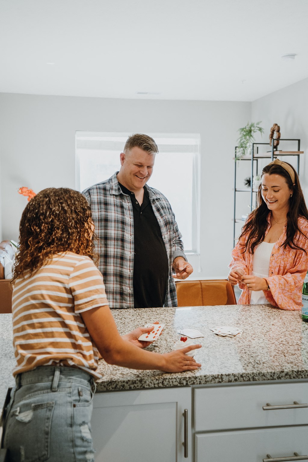 a group of people standing around a kitchen counter