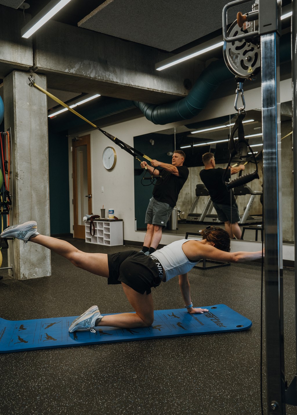 a group of people doing exercises in a gym