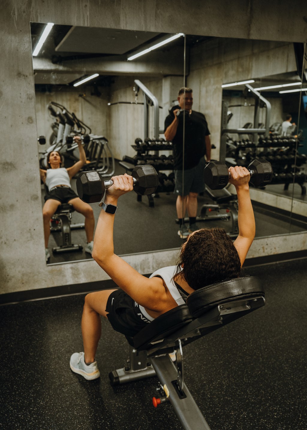 a group of people lifting weights in a gym