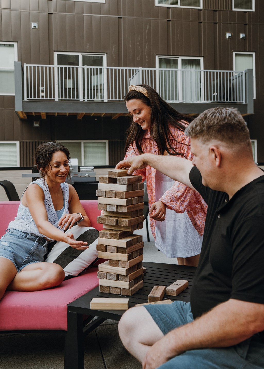 a group of people playing jenga in a living room