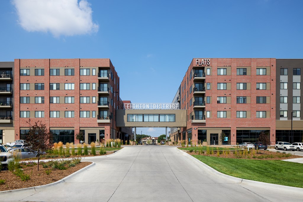 a large brick building with a road in front of it