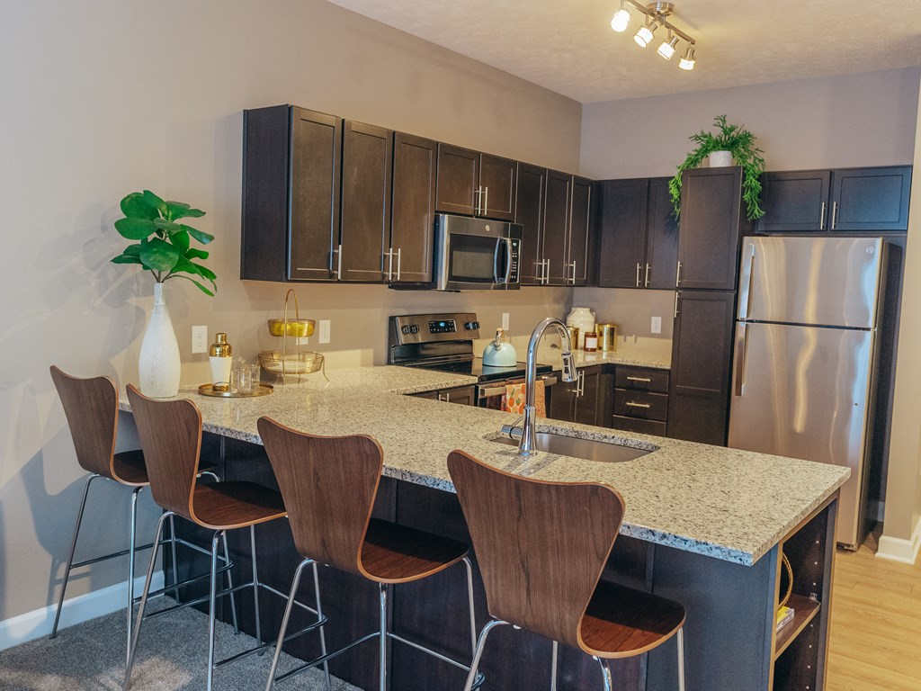 a kitchen with a marble counter top and stainless steel appliances