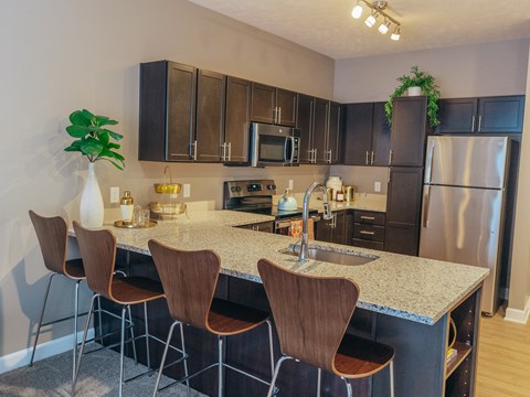 a kitchen with a marble counter top and stainless steel appliances