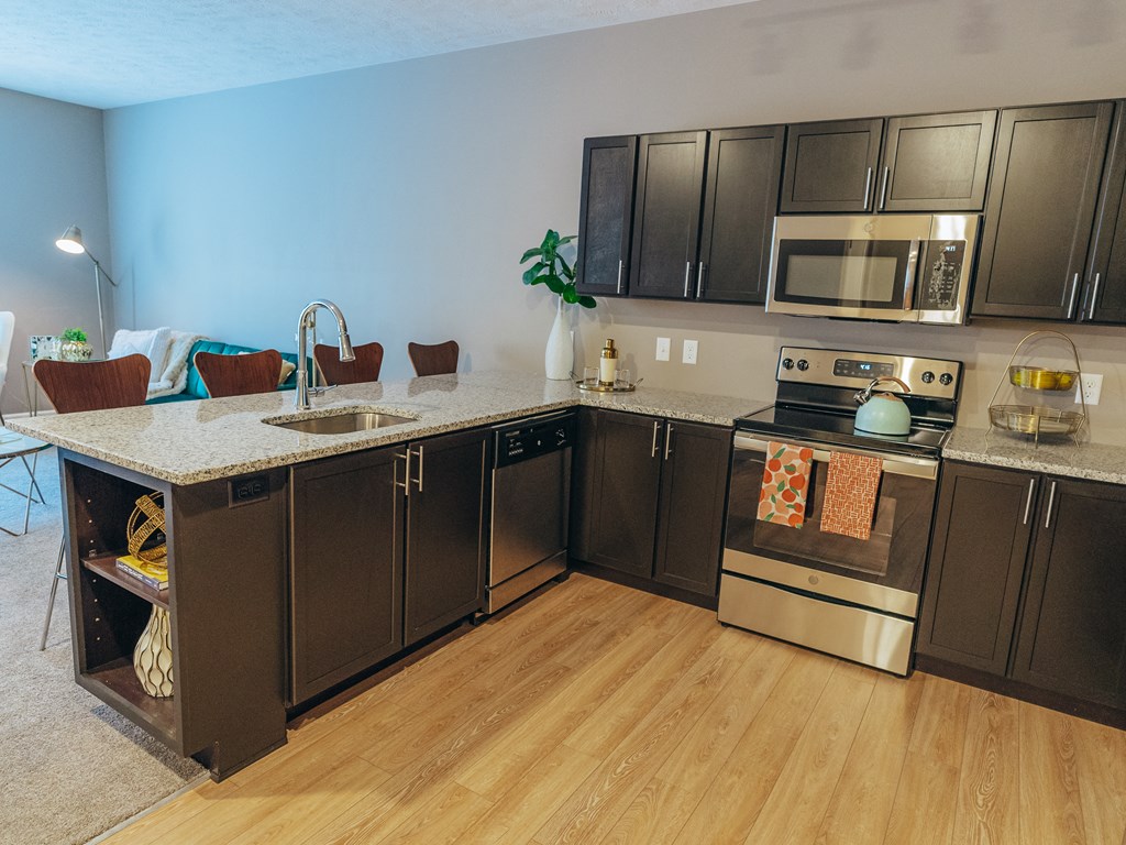 a kitchen with stainless steel appliances and a marble counter top