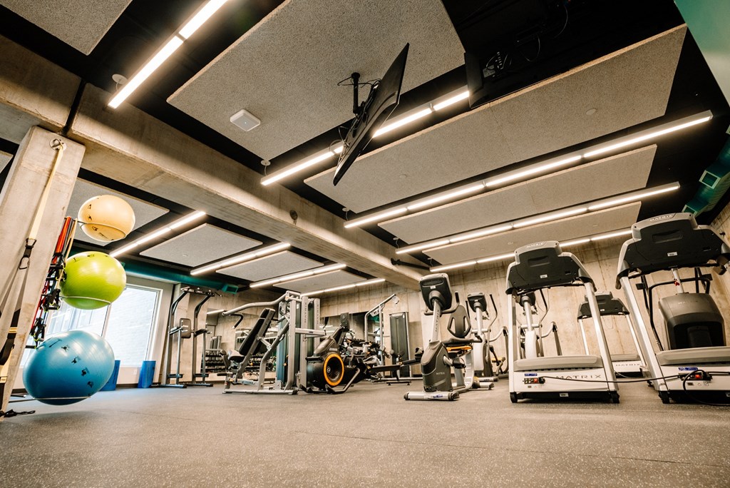 a gym with weights and other exercise equipment on the floor