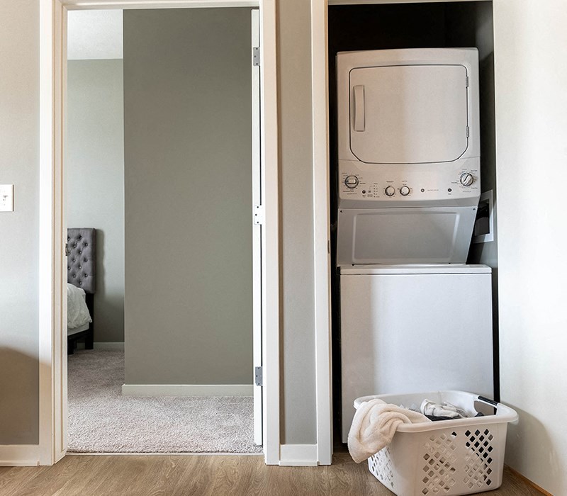 a small laundry room with a washer and dryer and a closet