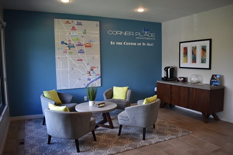 a living room with chairs and a table and a map on the wall