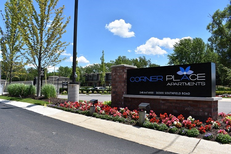 a sign for the corner place apartments on the side of the street