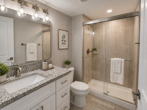 A bathroom with a sink, toilet, and shower.