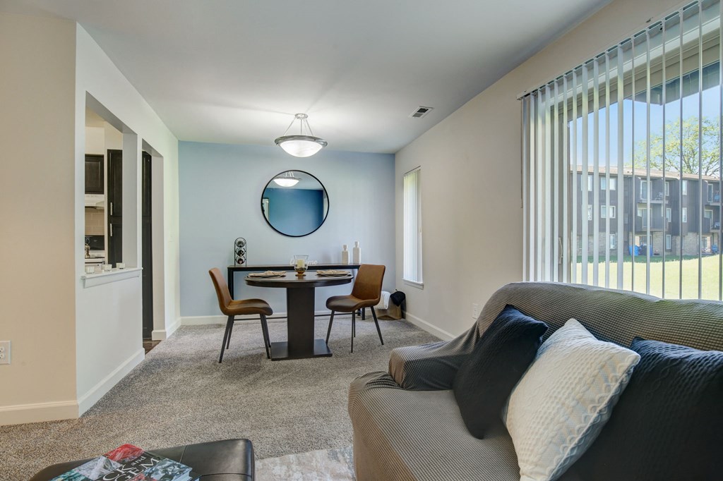 a living room with a couch and a table with chairs