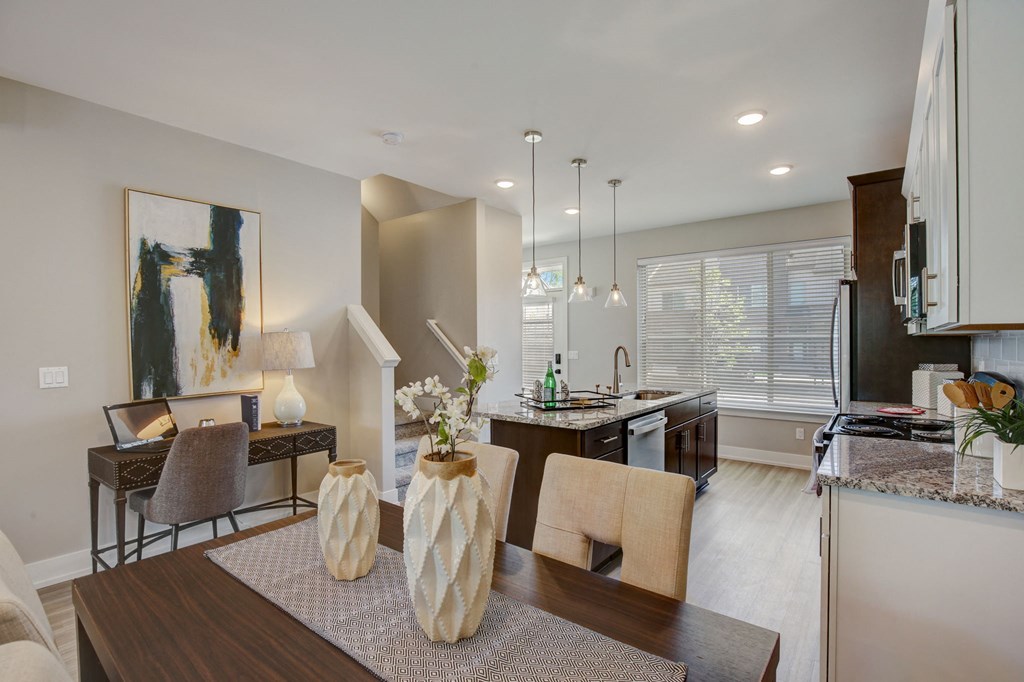 an open kitchen and dining room with a table and chairs