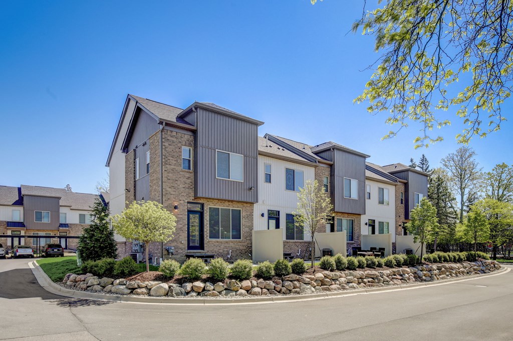 a row of apartment buildings with a street in front of them