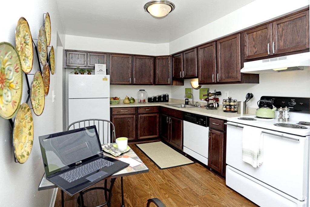 a kitchen with a laptop on a table
