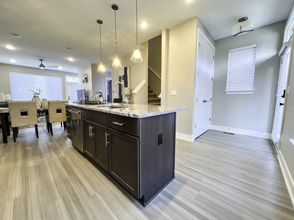 an open kitchen and dining room with a large island