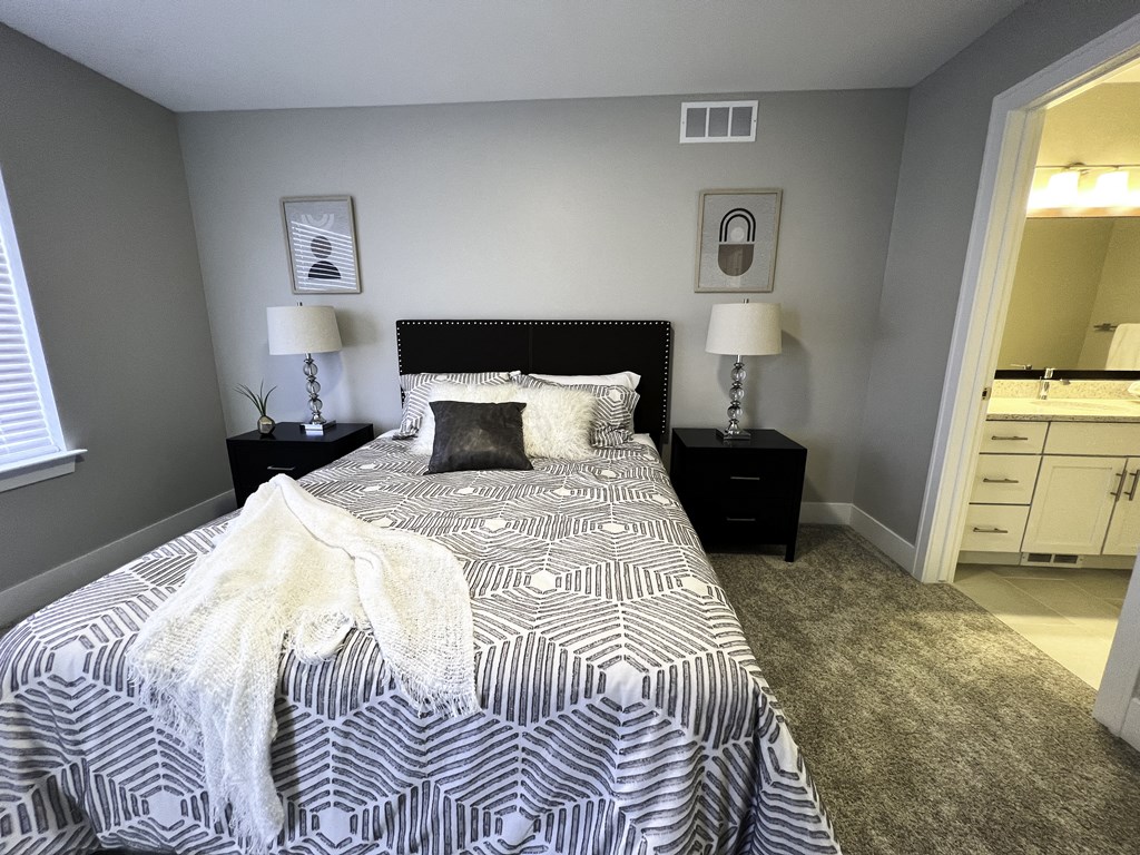 a bedroom with a black and white comforter on a bed
