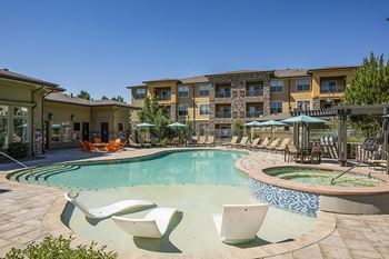 Resort-inspired pool with tanning shelf - Acadia at Corner