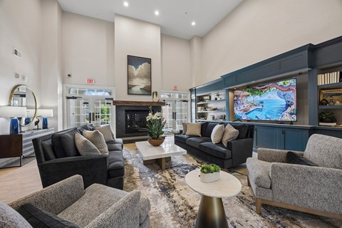 A living room with a fireplace and a television.