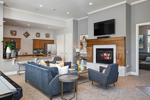 a living room with a fireplace and a table and chairs